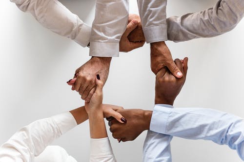 group of people holding hands