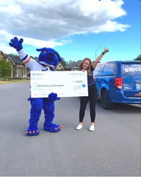 Hunter and Maddie holding a big check