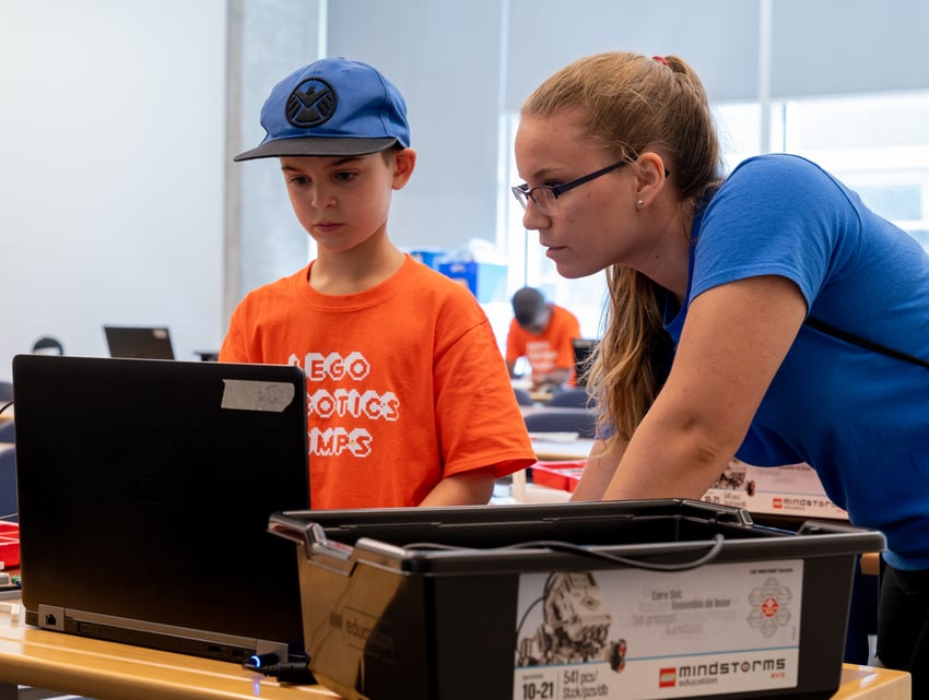 OTU student helping kid with task