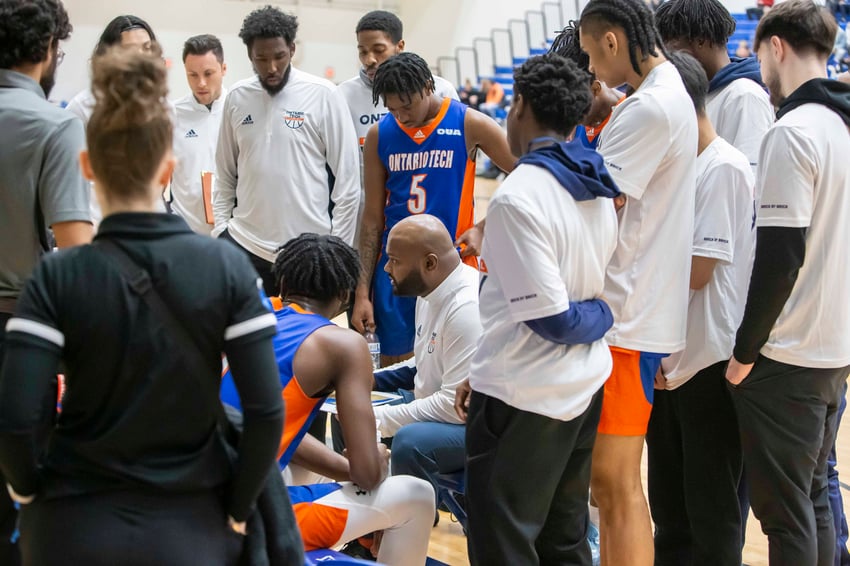 Ontario Tech basketball players and their coach