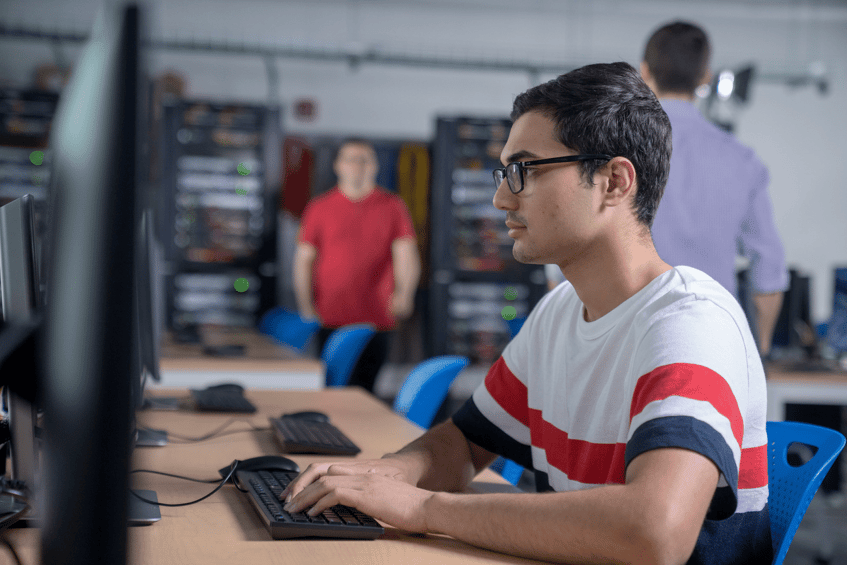 Student typing on a computer (1)