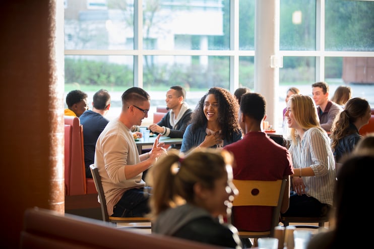 students talking at a table