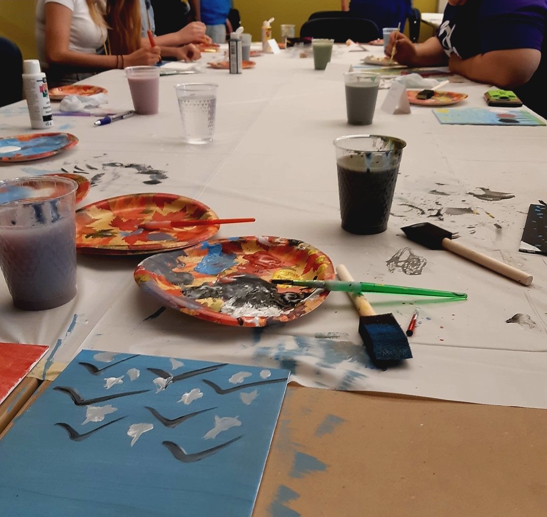 Featured in this image in a snapshot of students painting at the Pride Club's first paint and games mixer that was held for first-year students during the 2019/2020 Ontario Tech U Orientation.