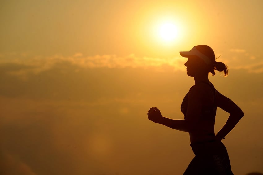 Woman going for a run at sunrise