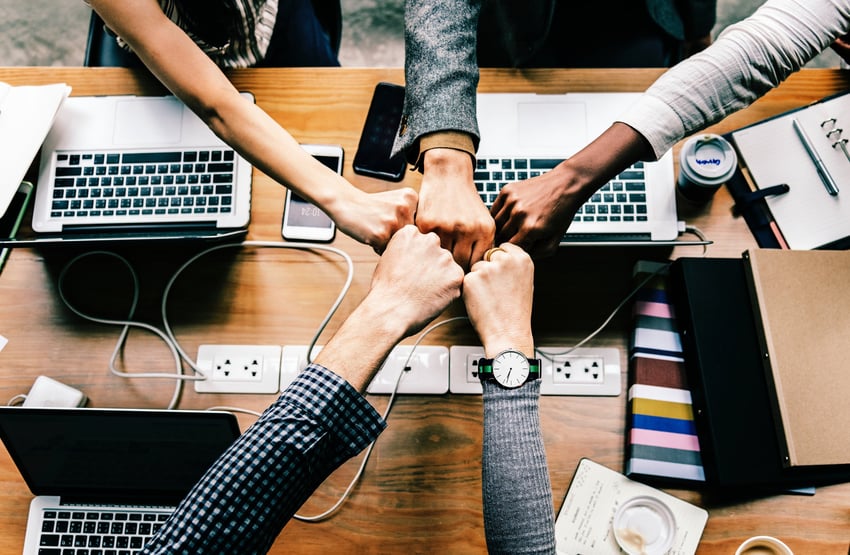 a group of people fist bump