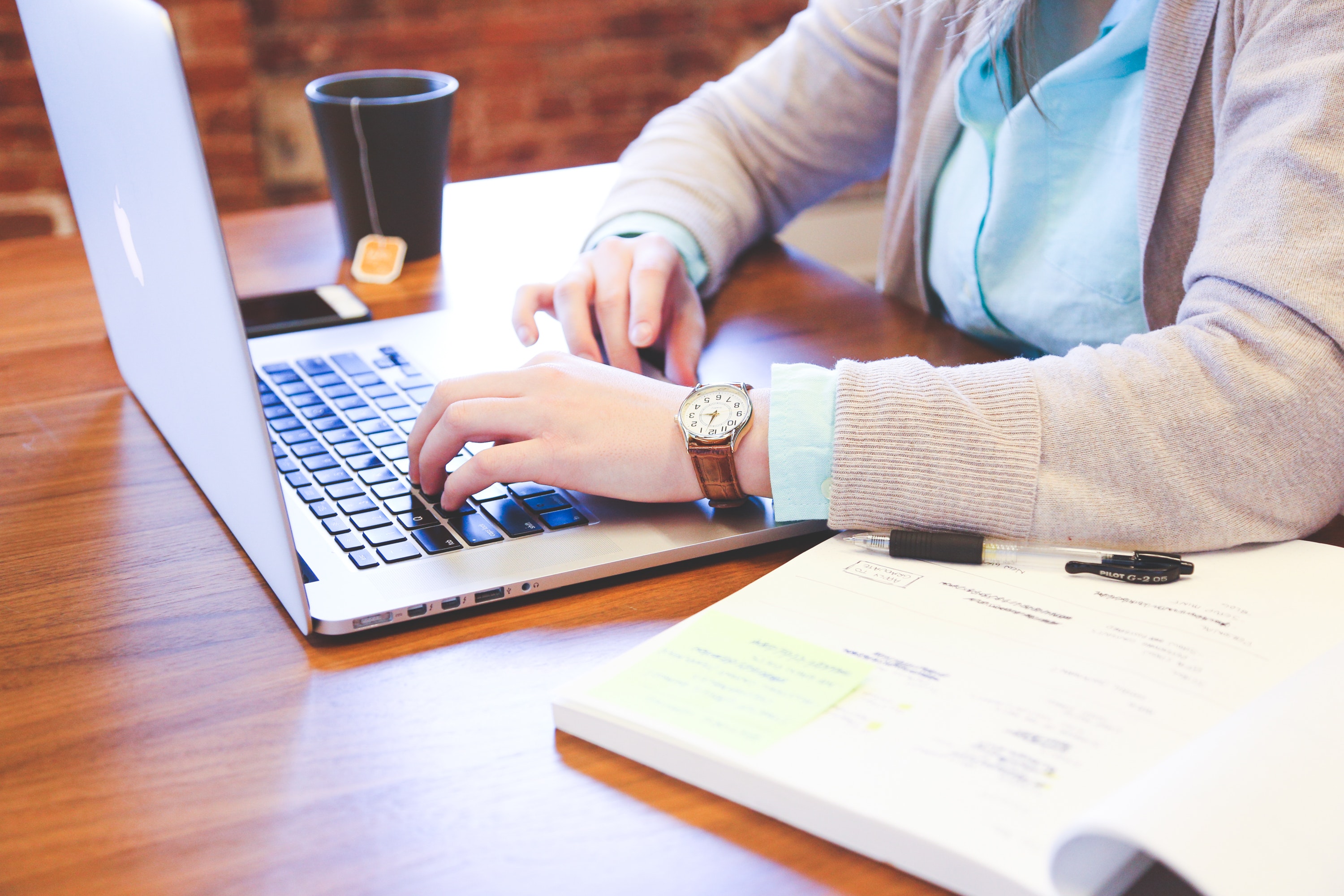 a person studying with a laptop and textbook