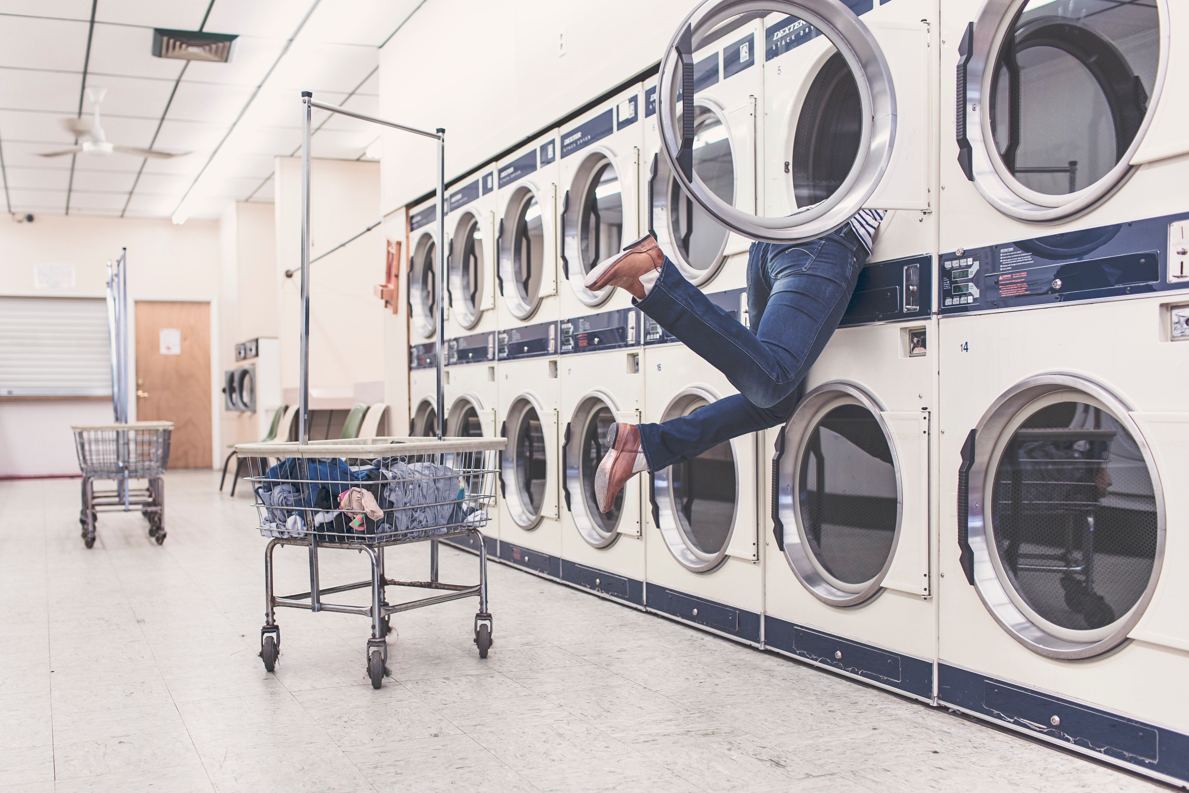 someone reaching into a laundry machine