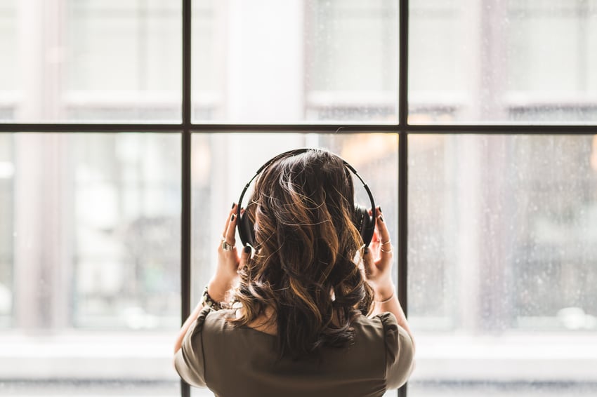girl listening to music through headphones