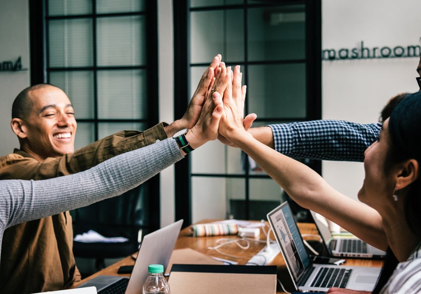 people happily high-fiving