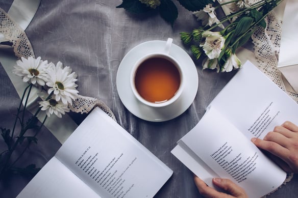 Romantic date reading a book with a cup of tea.