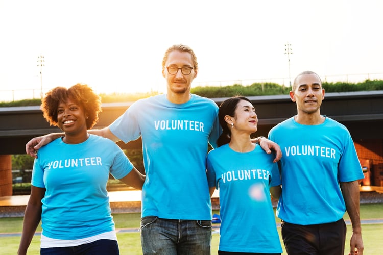 Four people with blue volunteer shirts