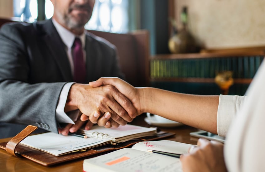 Man shaking woman's hand