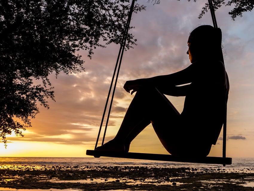 girl thinking on swing