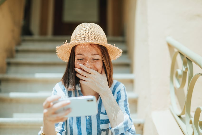 girl laughing at her phone