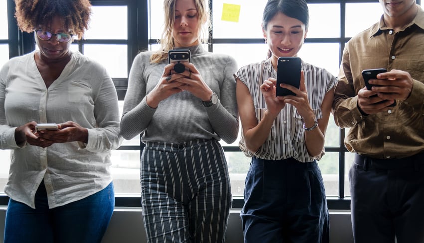 4 people looking at their phones