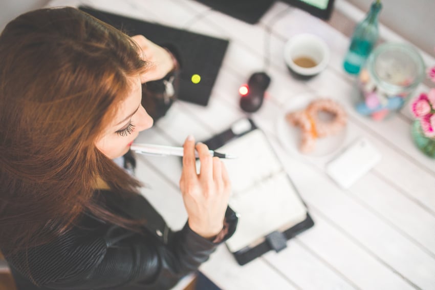 Girl day dreaming at a desk