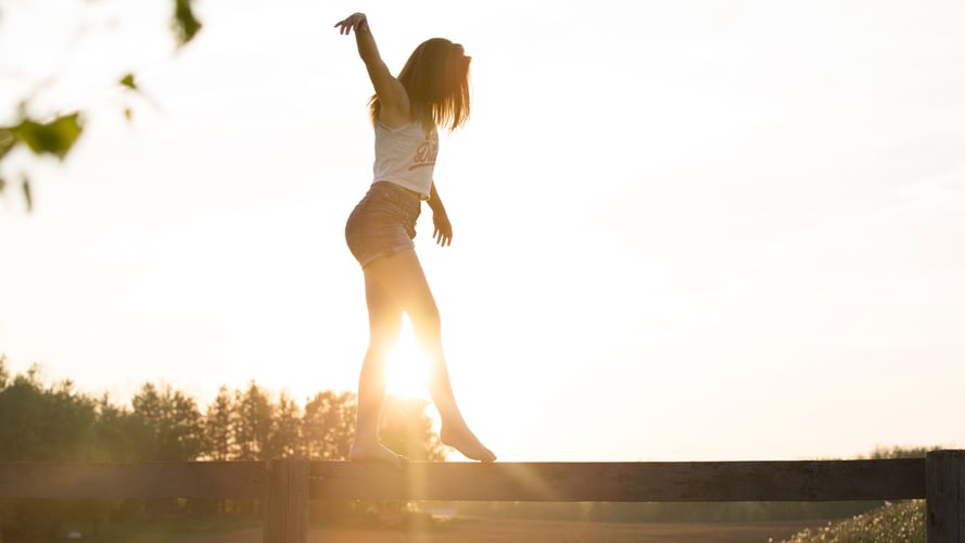 Girl balancing on log 