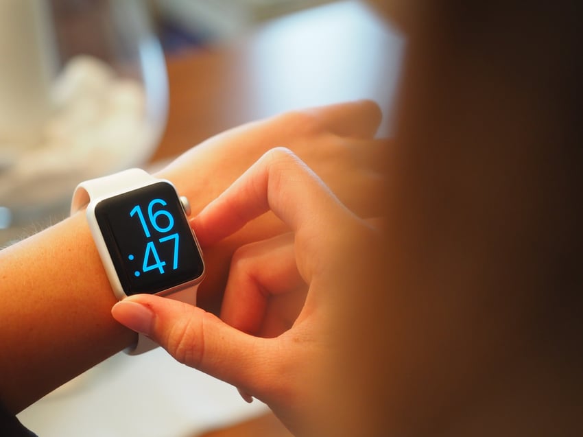 girl looking at her smart watch 