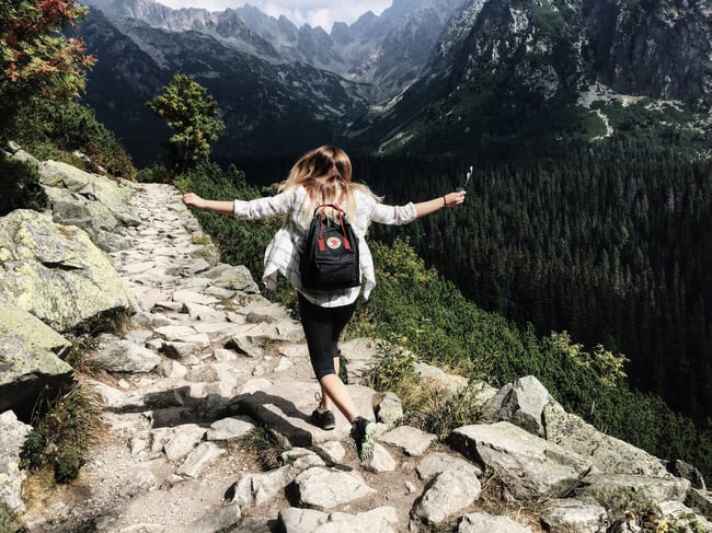 Woman climbing a mountain