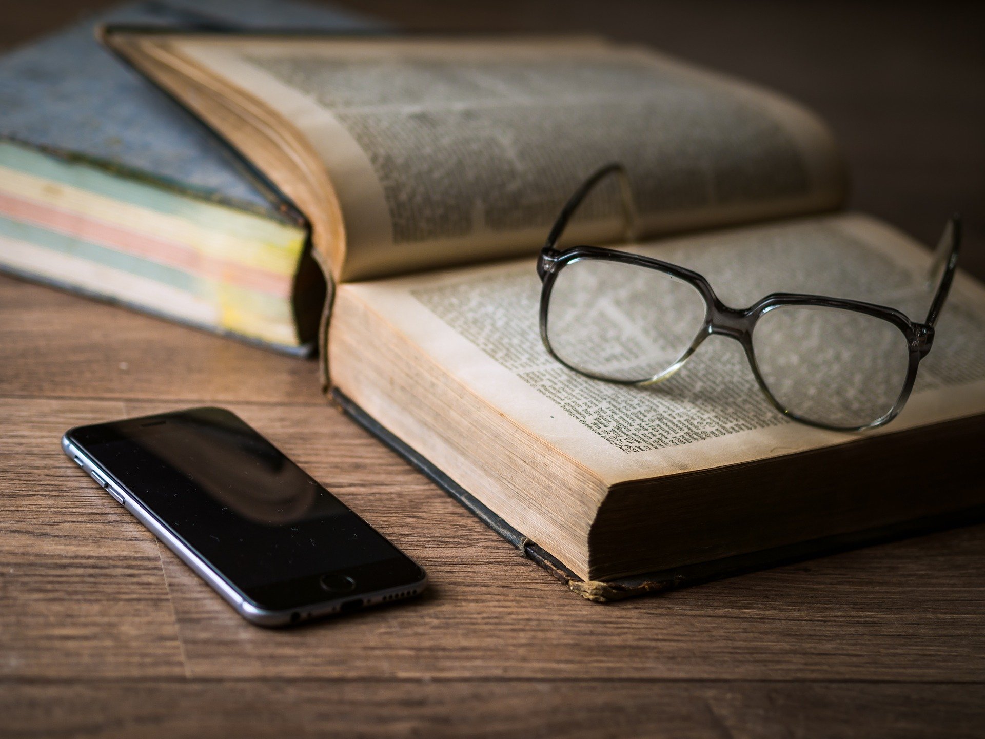 eye glasses resting on top of an open book