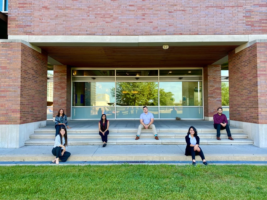 Students sitting on campus steps 