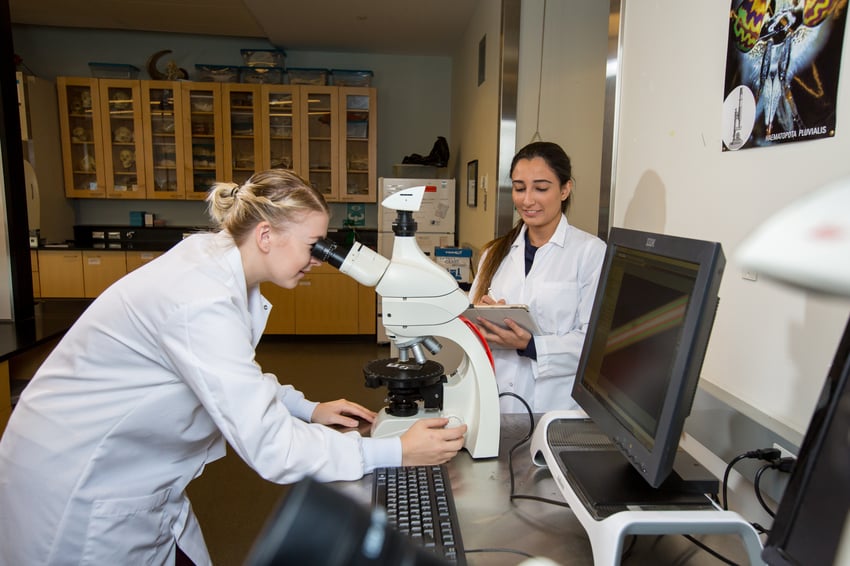 Two students in white lab coats in the laboratory