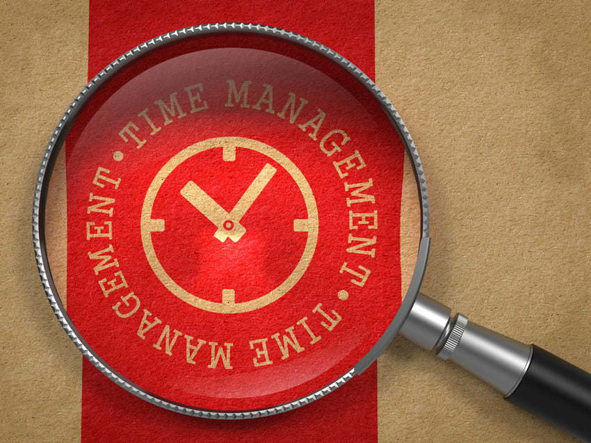 Magnifying glass over a time management graphic