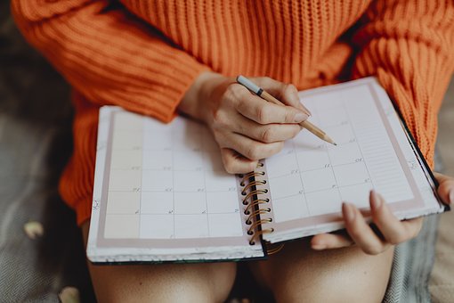 Person writing in a planner