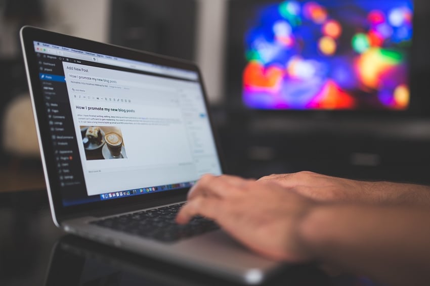 Person blogging on a laptop