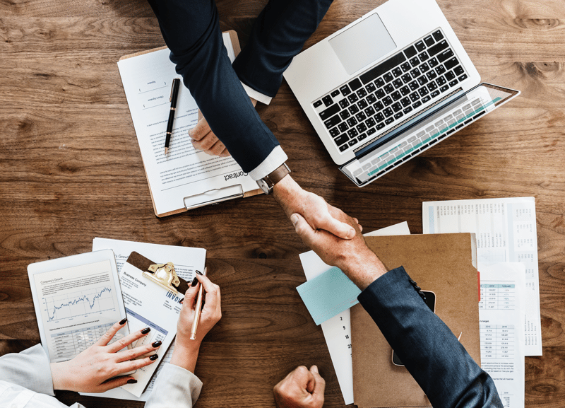 people shaking hands at a table