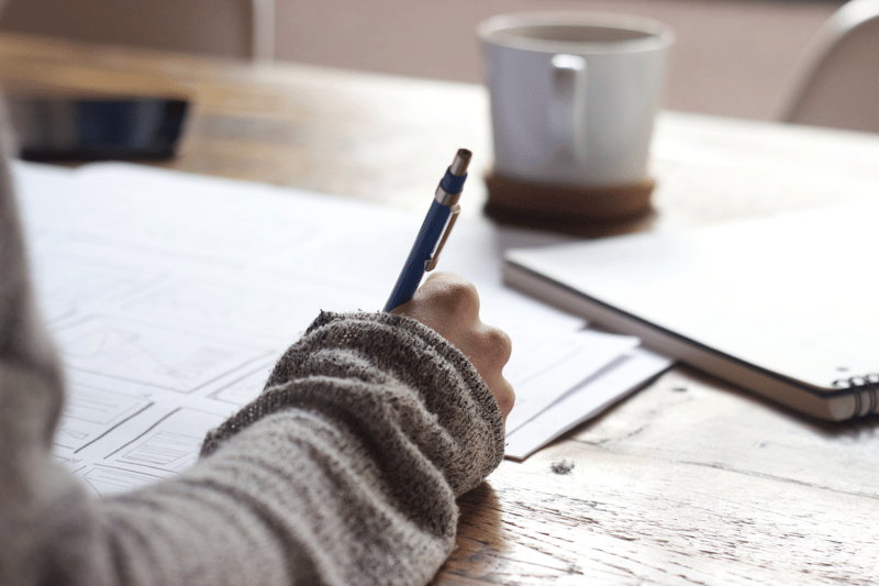 person taking notes at a table