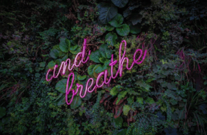 and breathe written in neon letters