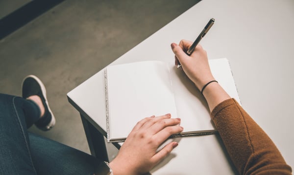 Person writing in a notebook