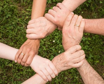 close up of people's hands holding each other's wrists