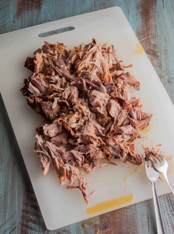 pulled pork on a cutting board.